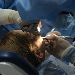 Dentist performing surgery