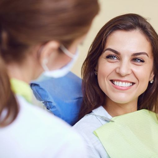 Woman smiling during her checkup and cleaning