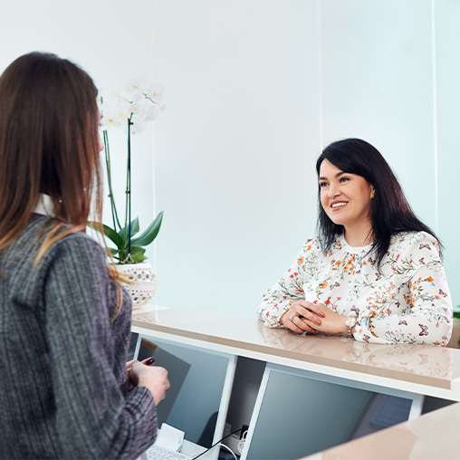 Dental patient talking to receptionist