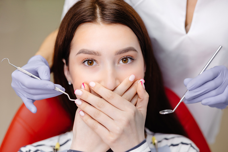 Patient covering their mouth after getting bargain dental implants